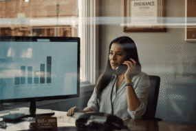 Independent insurance agent on a call with an AI-powered quote comparison on screen in a small-town agency office