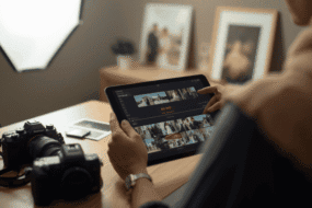 Photographer's hands culling a wedding photo gallery on a tablet using AI-assisted sorting